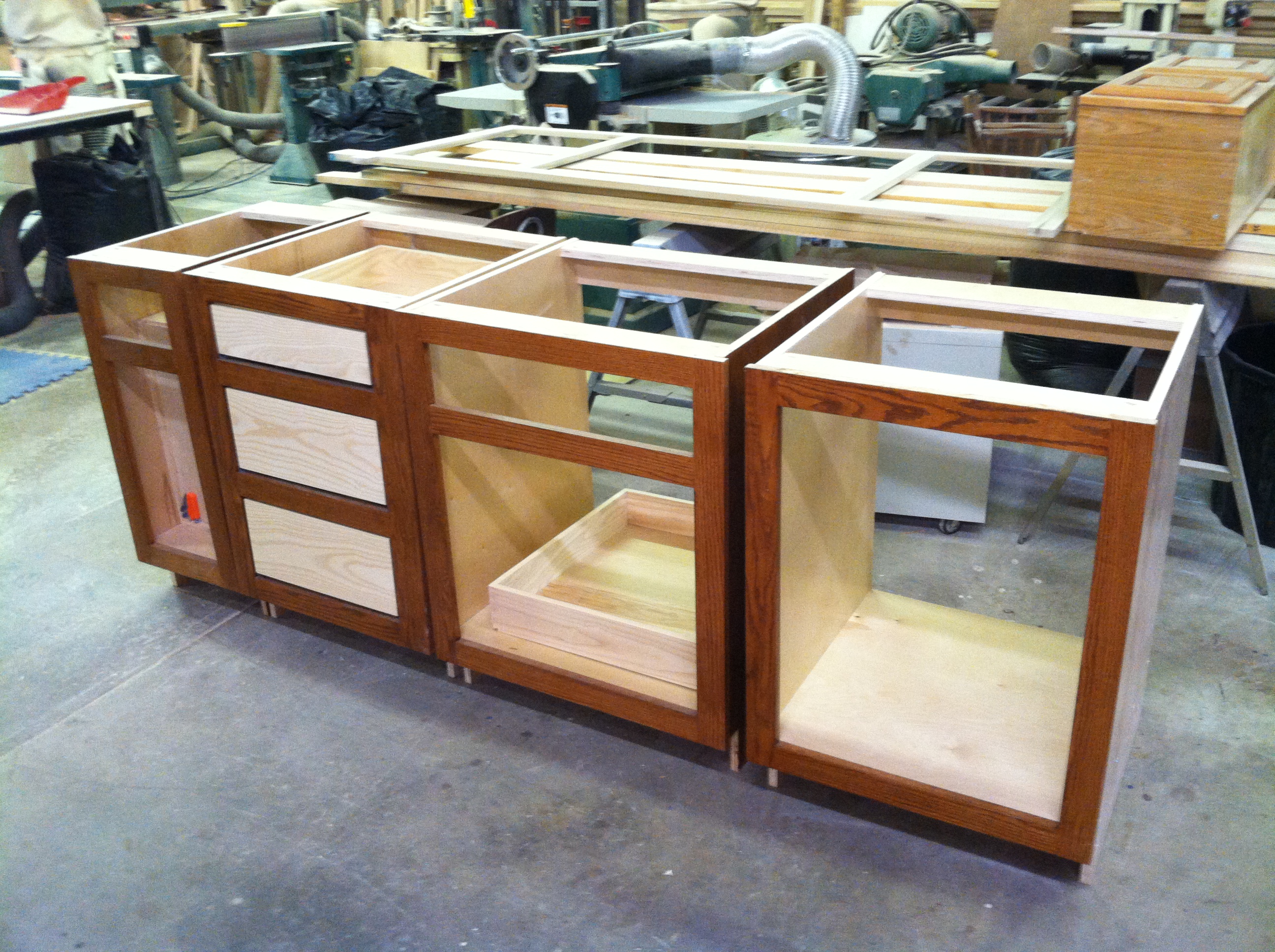 A kitchen cabinet during the process of mounting the cabinet drawers and doors.