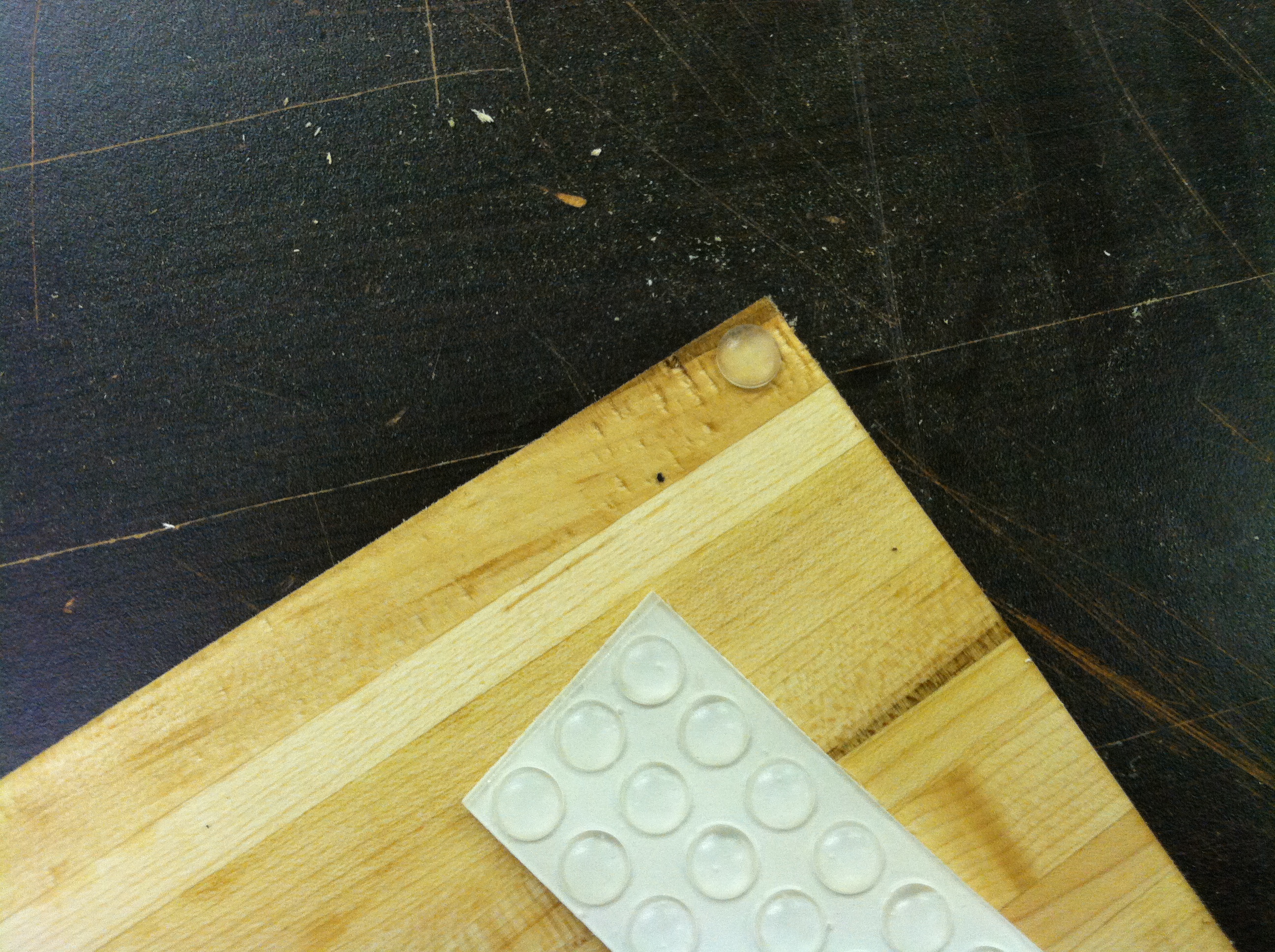 Maple cutting board with rubber pads attached to the bottom corners